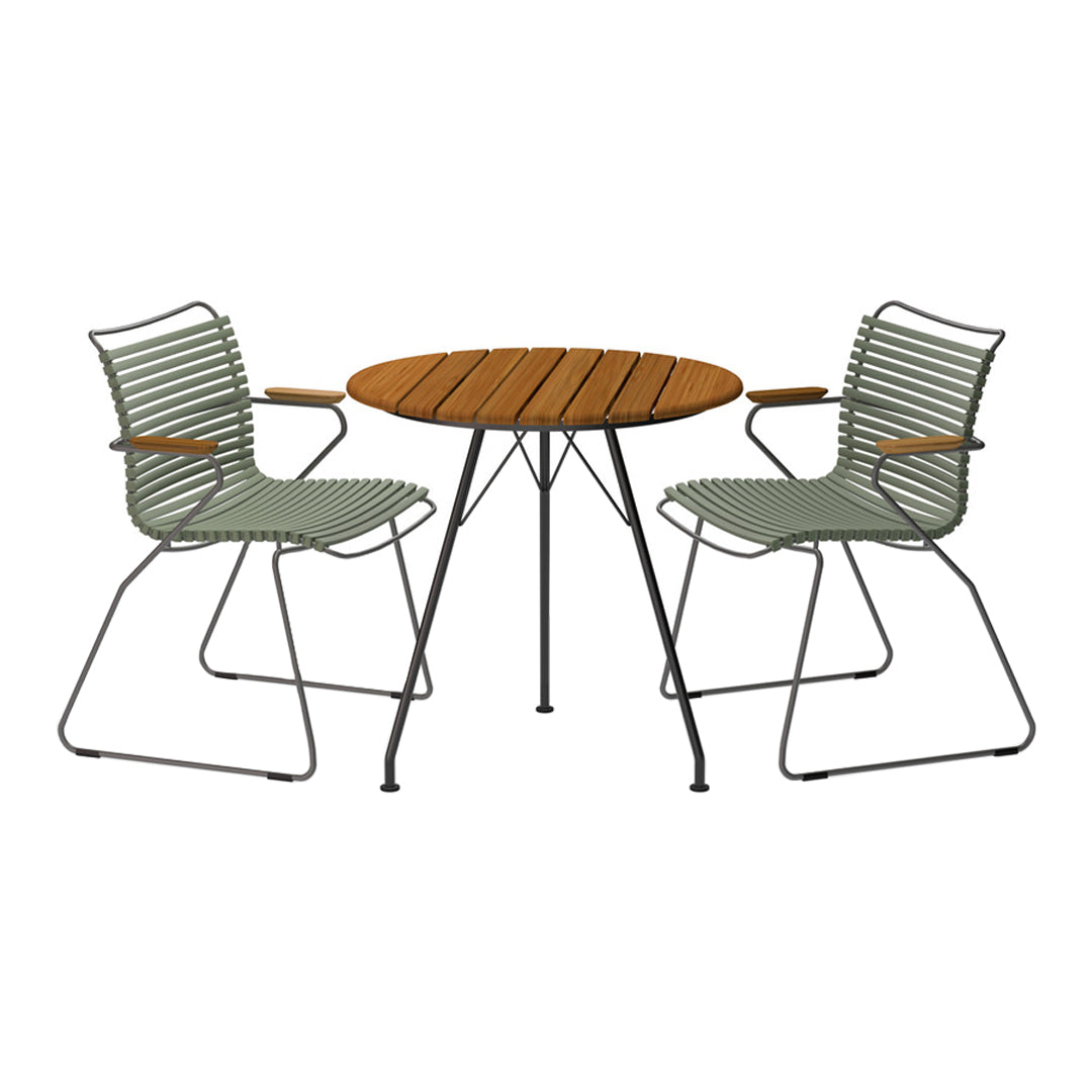 Green striped chairs paired with a round wooden table create a modern outdoor dining set.