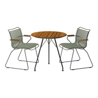 Green striped chairs paired with a round wooden table create a modern outdoor dining set.