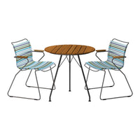 Striped blue and white pattern on chairs with a round wooden table, creating a vibrant outdoor dining set.