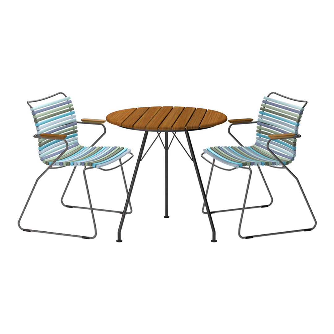 Striped blue and white pattern on chairs with a round wooden table, creating a vibrant outdoor dining set.
