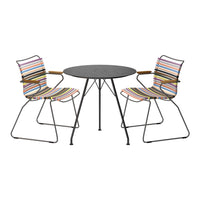 Multicolored striped chairs and a sleek black tabletop create a vibrant outdoor dining set. Perfect for stylish gatherings.