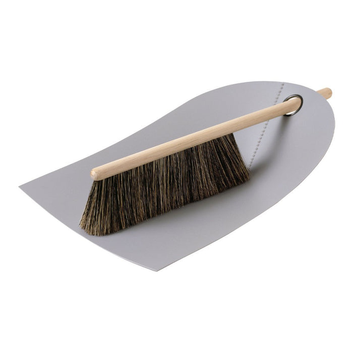 Gray dustpan with a brown bristle broom, showcasing a minimalistic design and natural wood handle.