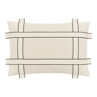 Beige pillow with black grid pattern and contrasting lines, perfect for modern decor.
