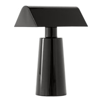 Black modern table lamp with a geometric design and sleek, shiny finish. Perfect for contemporary decor.