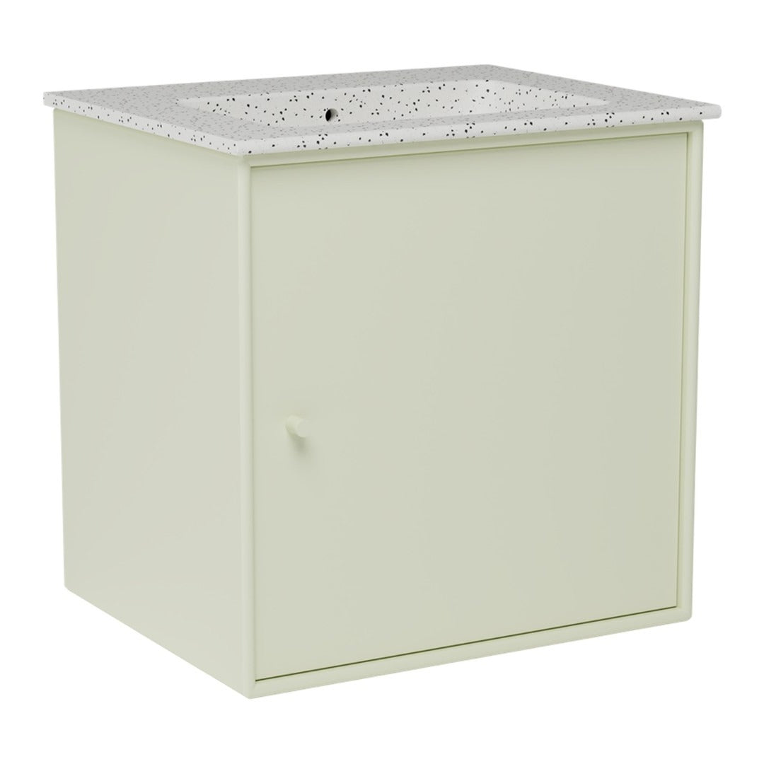 Light green cabinet with a speckled white countertop, featuring a minimalist design and smooth surfaces.