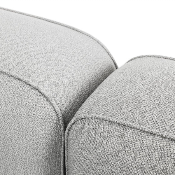 Light gray textured fabric cushions with subtle patterns, enhancing modern decor with a stylish touch.