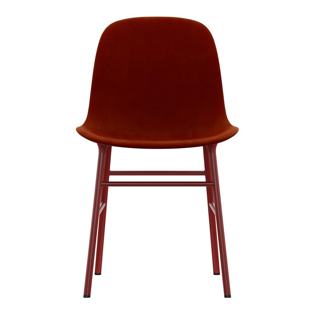 Rust velvet chair with smooth curves and matching red legs, perfect for stylish home decor.