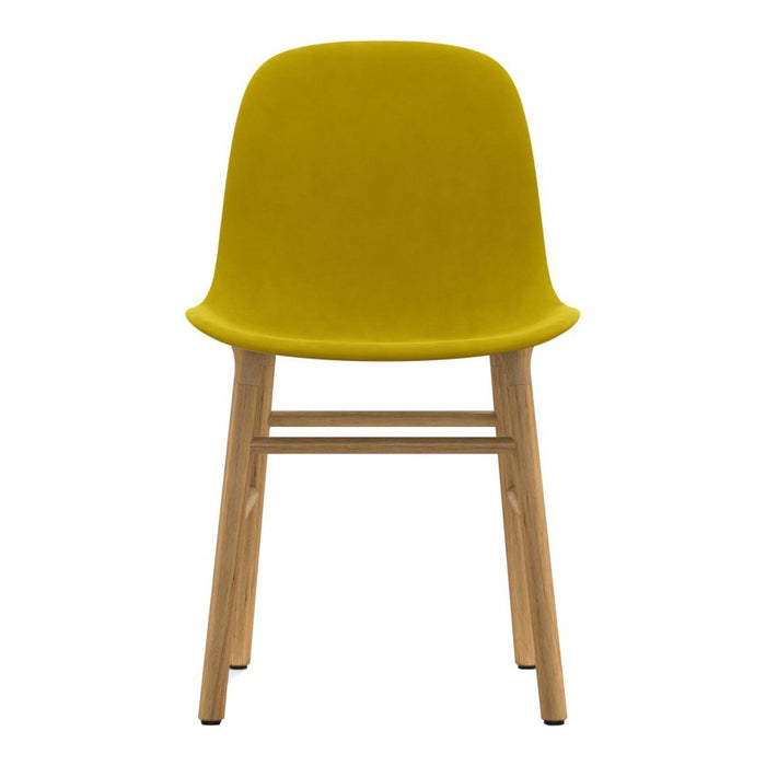 Bright yellow velvet chair with natural wood legs, featuring a sleek, modern design and smooth finish.