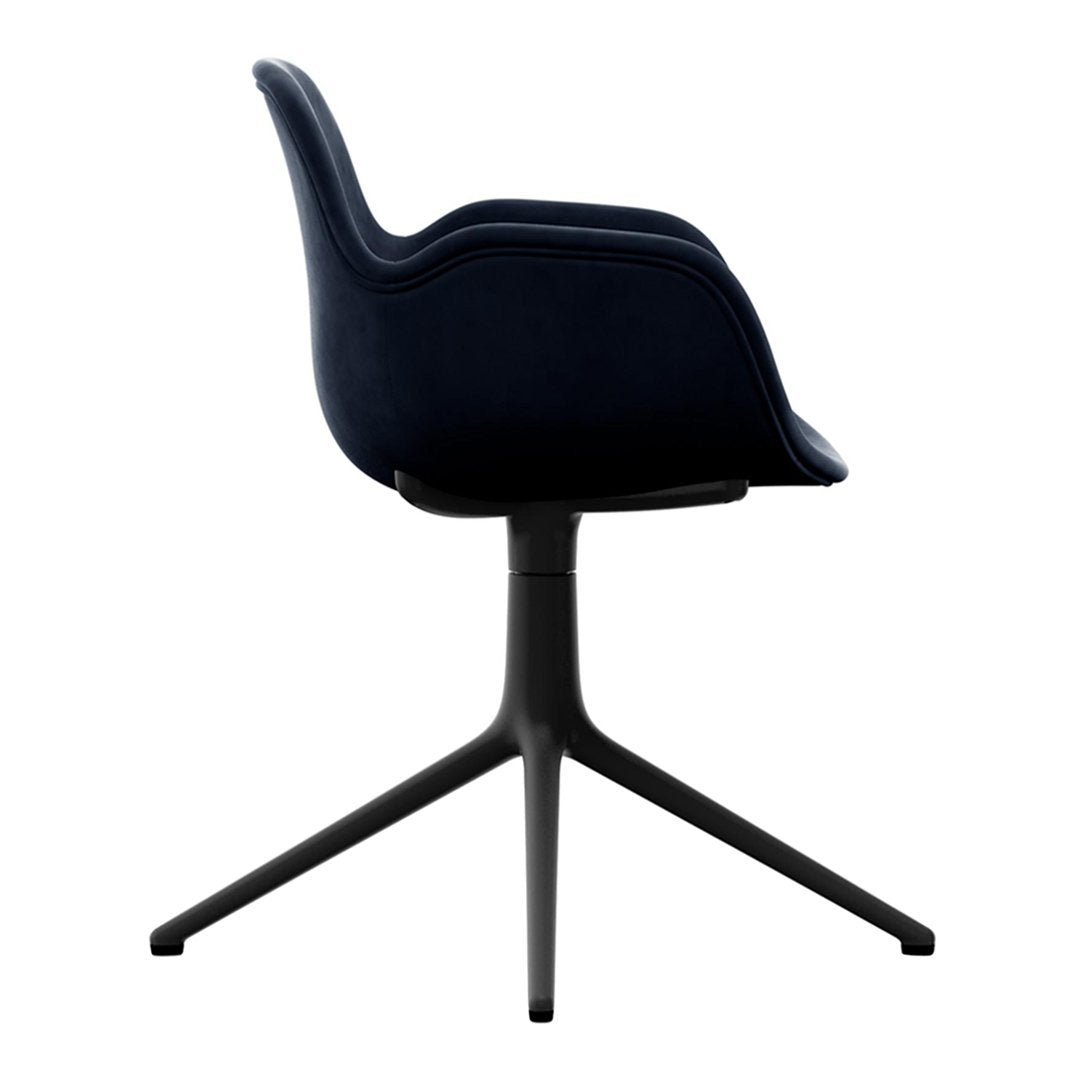 Navy blue upholstered chair with sleek silhouette and black accent base, perfect for modern decor.