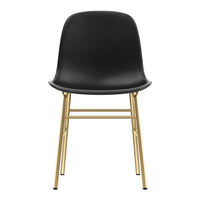 Black chair with a sleek molded seat and gold metal legs, offering a modern and minimalist design.
