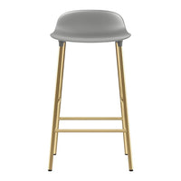 Gray padded stool with sleek gold legs, perfect for modern decor. Minimalist design complements any setting.