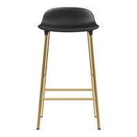Black bar stool with a sleek, curved seat and elegant gold metal legs. Modern minimalistic design.
