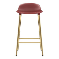 Red bar stool with a smooth finish and gold metal legs, featuring a minimalist design. Perfect for modern decor.