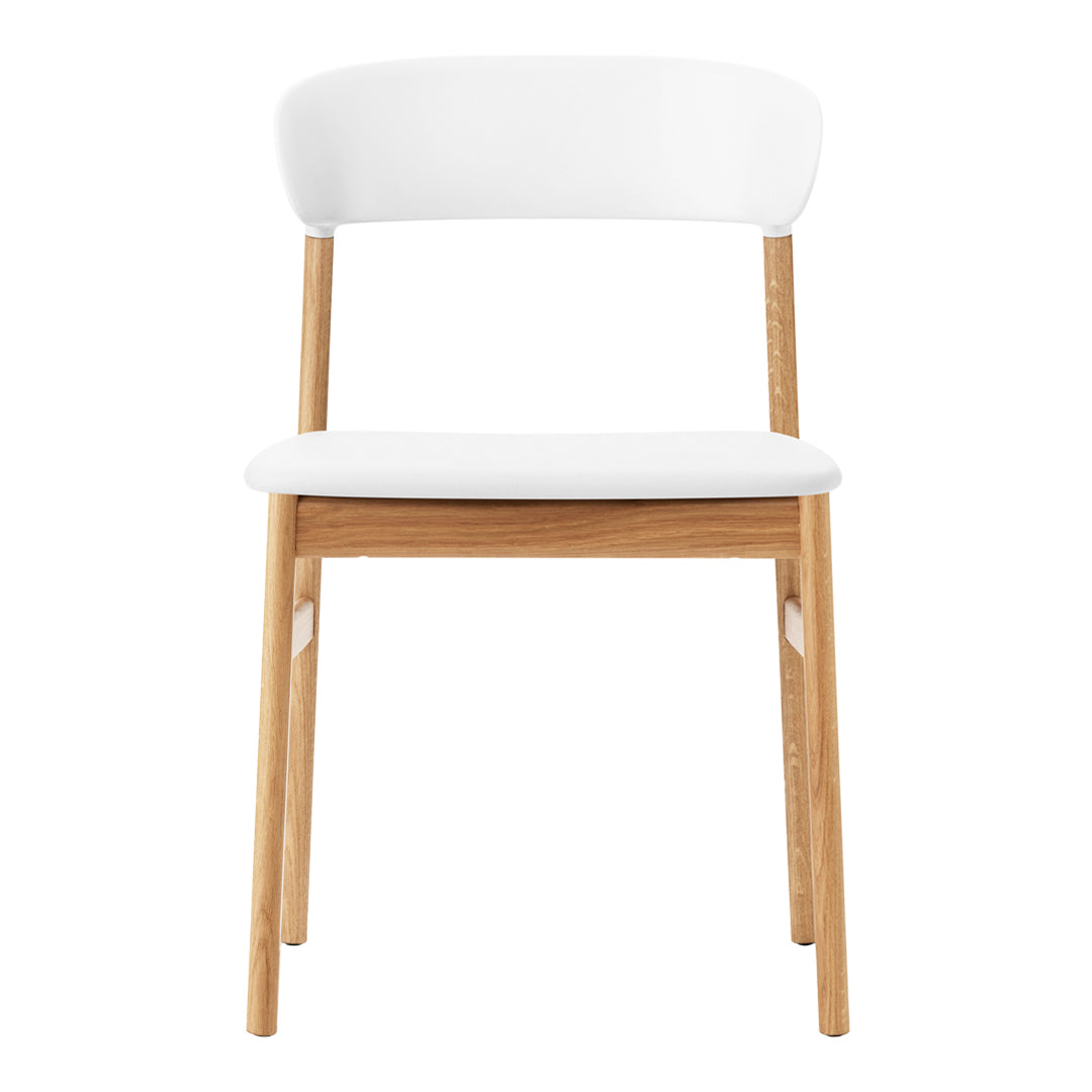 White chair with a minimalistic design and light wood legs, featuring a smooth, clean aesthetic.
