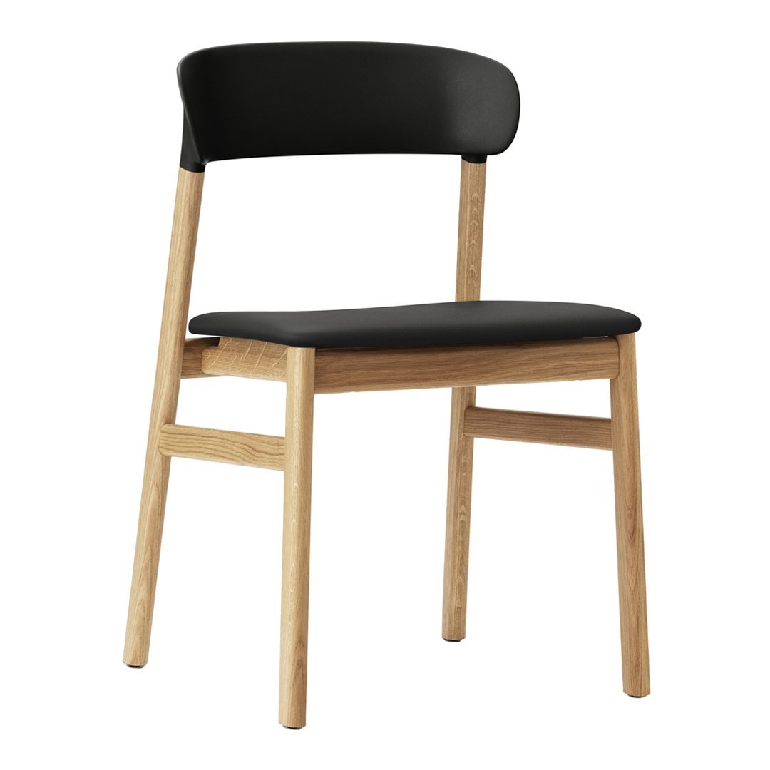 Black wooden chair with a smooth, minimalist design and natural wood legs, perfect for modern decor.