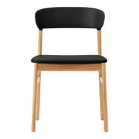 Black upholstered chair with a natural wood frame. Minimalist design featuring solid colors and smooth lines.