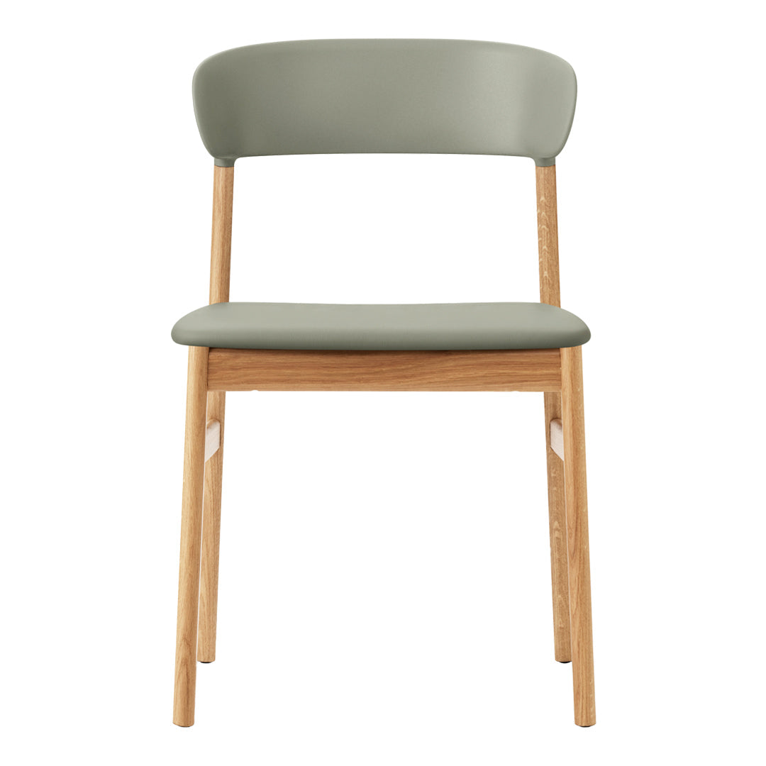"Solid oak chair with a soft green seat and backrest, featuring a minimalist design with smooth lines."