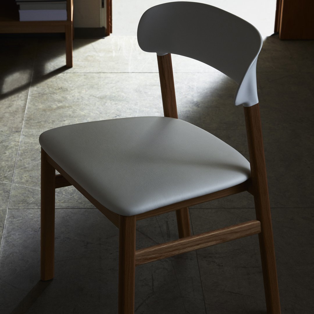 Modern chair featuring a sleek white seat and a natural wood frame, perfect for contemporary decor.