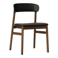 Black chair with a smooth finish and wooden legs, featuring a minimalist design. Perfect for modern decor.