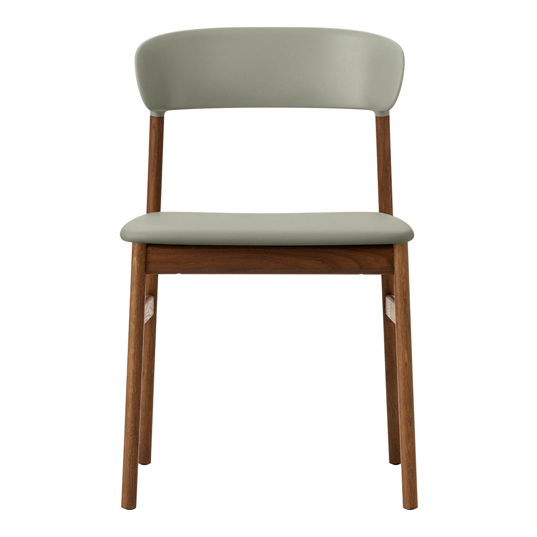 "Minimalist chair with a soft green seat and backrest, paired with natural wood legs."