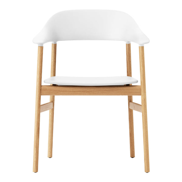 White chair with a smooth, curved back and natural wood legs, showcasing a minimalist and modern design.