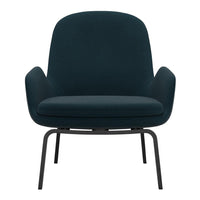 Teal upholstered armchair with a smooth, minimalistic design and sleek black metal legs.