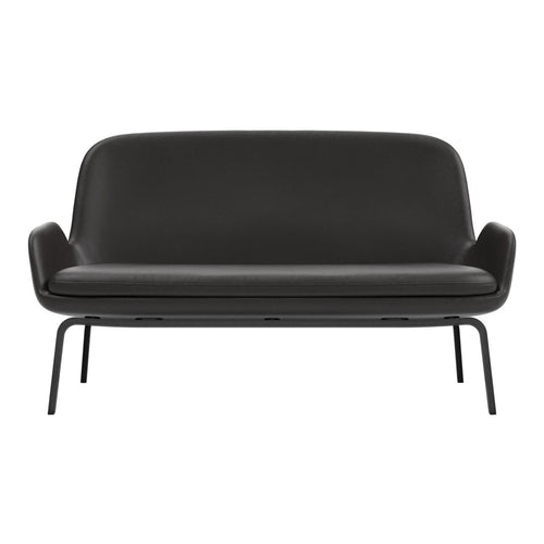 Black leather sofa with a smooth, minimalist design and sleek metal legs. Perfect for modern decor.