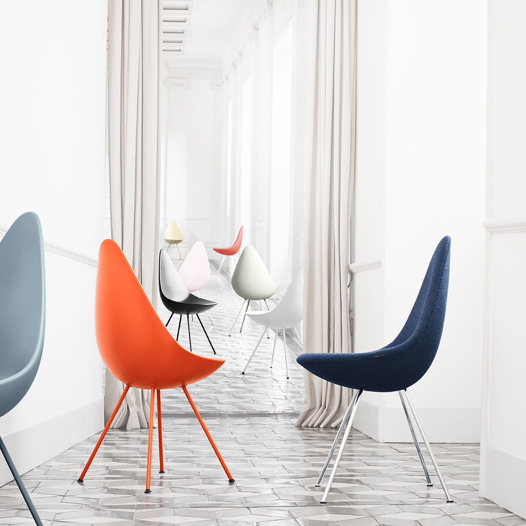 Colorful modern chairs in blue, orange, gray, white, and pink, with sleek lines and minimalist design patterns.