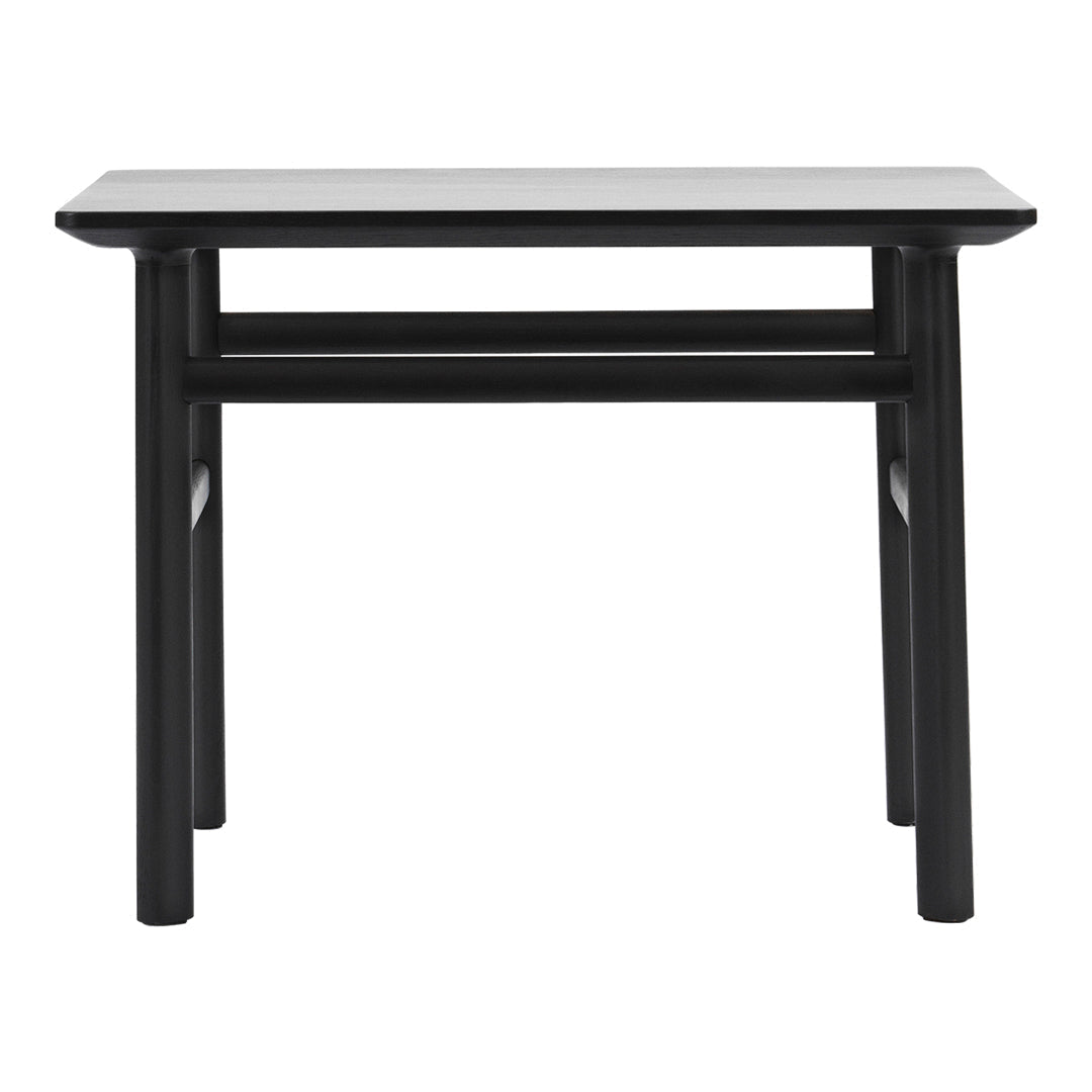Black wooden table with a smooth rectangular top and straight legs. Sleek and minimalistic design.