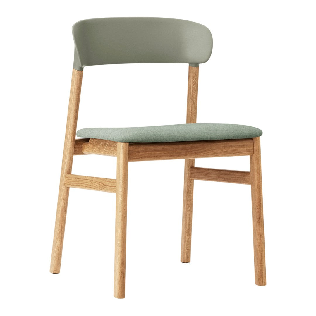Modern chair with light wood frame and soft green seat and backrest, featuring a minimalist design.