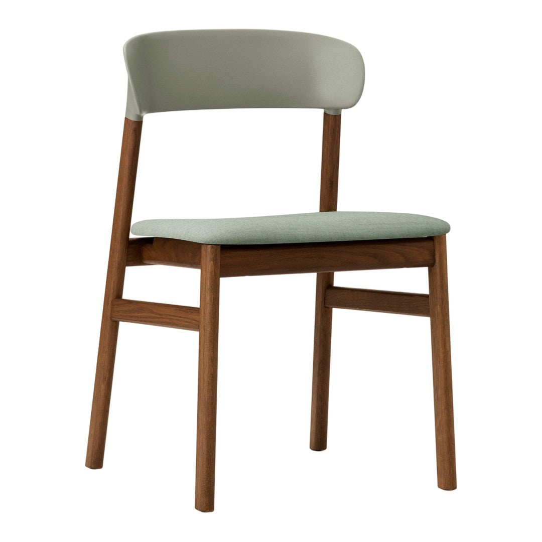 Light green upholstered chair with a natural wood frame, featuring a sleek, modern design and minimalist style.