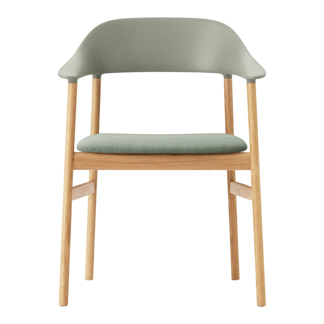 Light green chair with a smooth finish and wooden legs, featuring a minimalist design and soft upholstered seat.