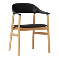 Black upholstered chair with natural wood legs, featuring a sleek, minimalist design. Ideal for modern interiors.