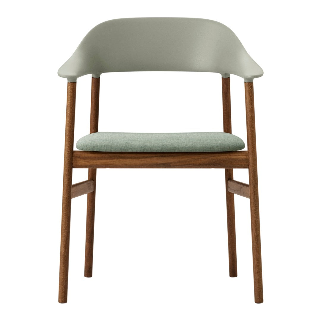Light green chair with a rounded back and wooden legs, showcasing a minimalist design. Soft fabric seat cushion.