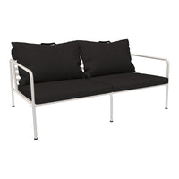 Black fabric cushions on a minimalist white frame, offering a sleek and modern look. Perfect for outdoor or patio decor.