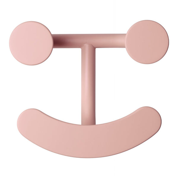 Round blush pink wall hook with a smiling face design. Smooth, minimalist pattern adds playful charm to any space.