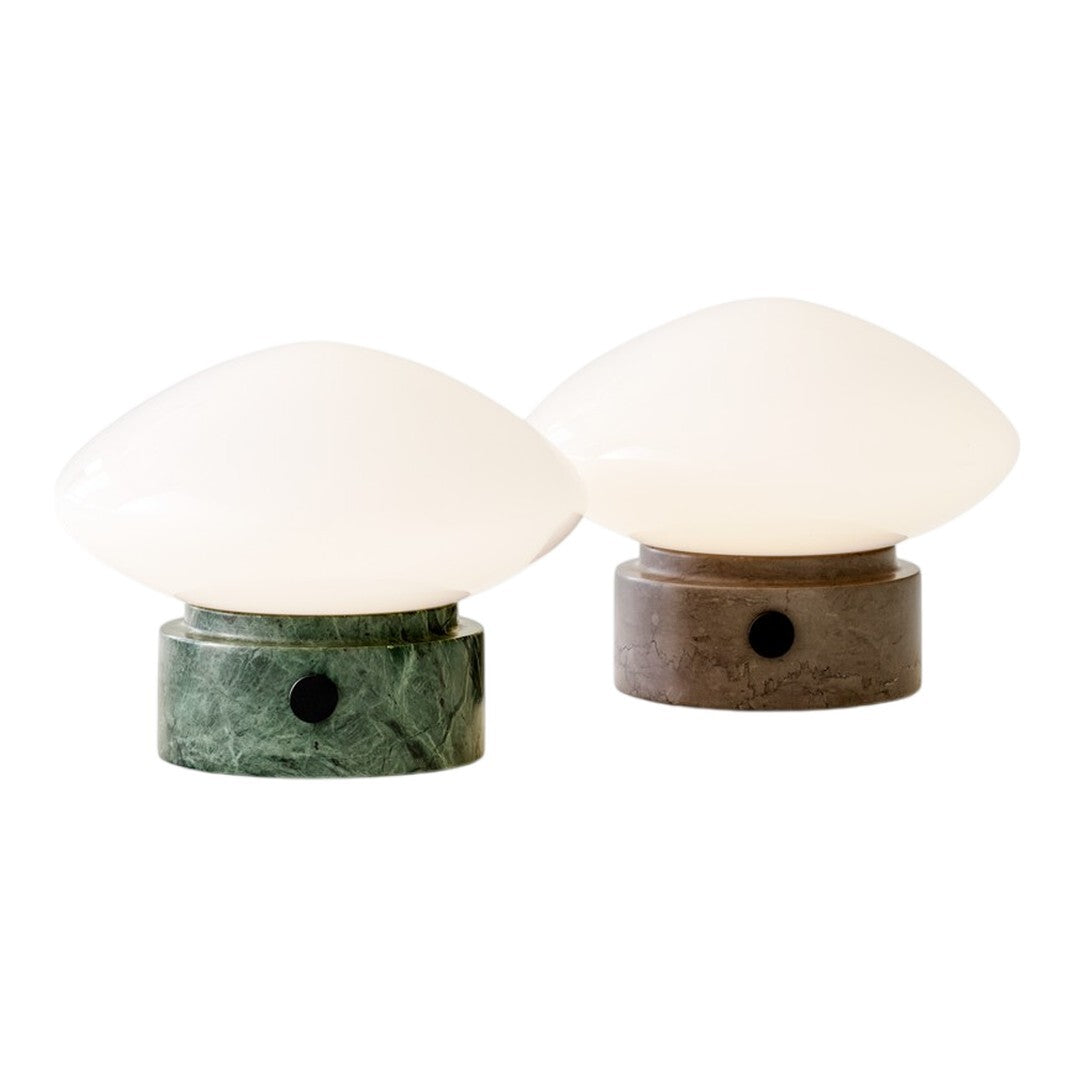 Green and grey marble base table lamps with glossy white glass shades, featuring smooth, contemporary shapes.