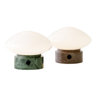 Green and grey marble base table lamps with glossy white glass shades, featuring smooth, contemporary shapes.