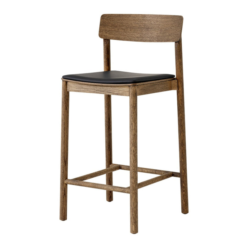 Wooden bar stool with a natural finish and black cushioned seat, showcasing a sleek, modern design.