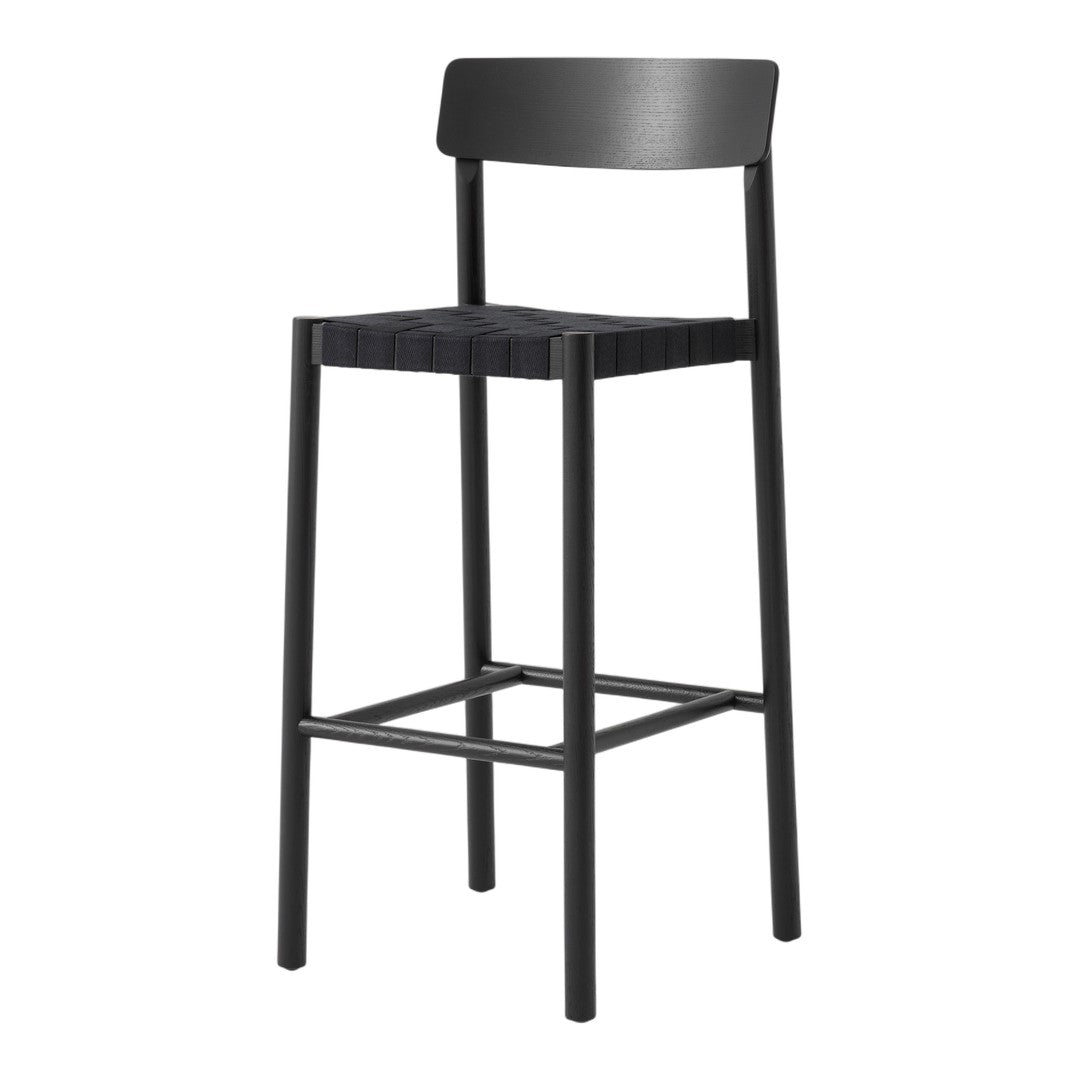Black bar stool with a sleek design and a matte finish, featuring a simple, modern pattern. Perfect for minimalist decor.