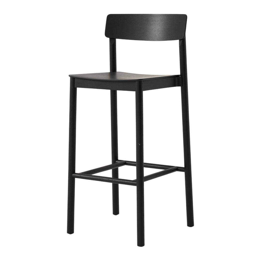 Black bar stool with a simple, sleek design and minimalistic patterns. Ideal for modern interiors.