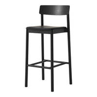 Black bar stool with a sleek, minimalist design and smooth matte finish. Perfect for modern decor.