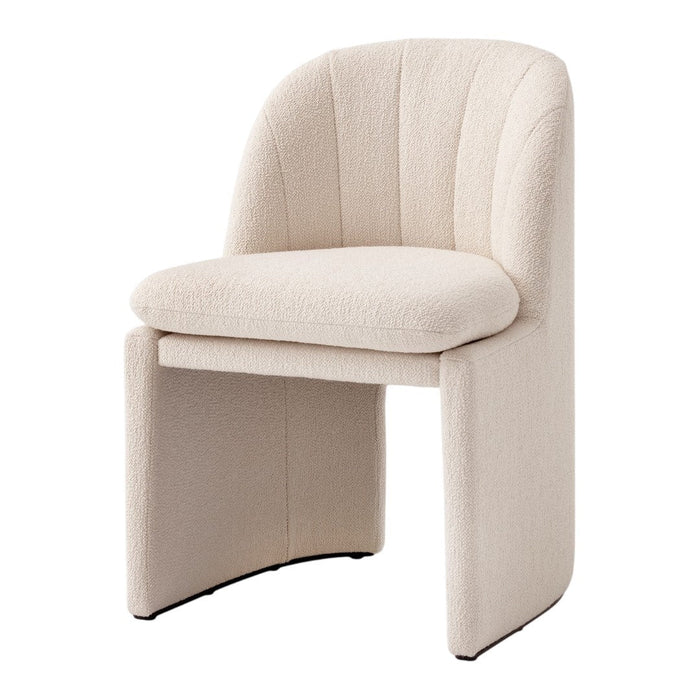 Beige textured chair with curved back and seat, featuring subtle stitch patterns for a modern, cozy aesthetic.