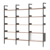 Modern black metal shelving unit with natural wood shelves and a sleek white cabinet, showcasing minimalist design.