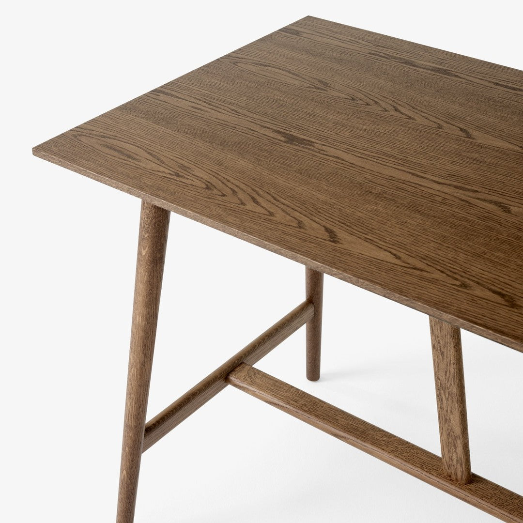 Brown wooden table with a smooth, natural grain and tapered legs, featuring a minimalist design.