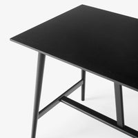 Sleek black tabletop with minimalist design, complemented by slender black legs for a modern aesthetic.
