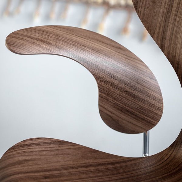 Smooth walnut wood grain pattern with curved shapes and sleek finish. Ideal for modern decor.