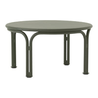 Round green metal coffee table with smooth surface and curved legs, ideal for modern decor.