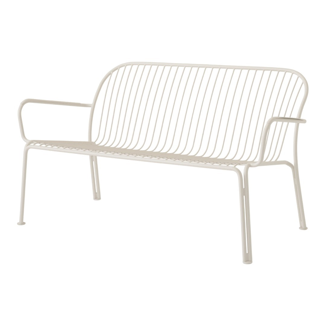 Cream-colored metal bench with a modern, minimalistic striped pattern and sleek armrests. Perfect for outdoor spaces.