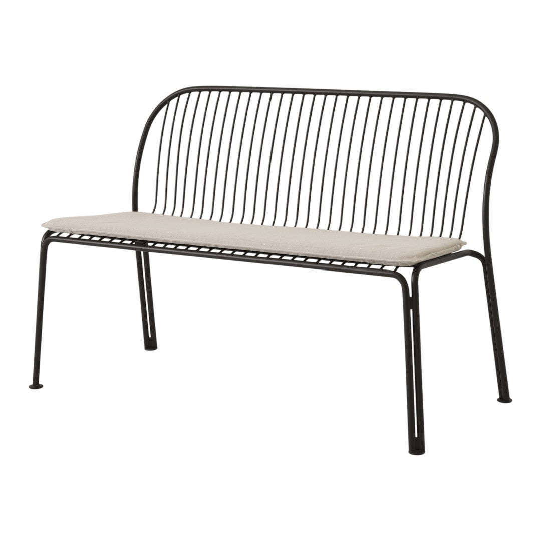 Black metal bench with a minimalist design and a neutral cream cushion. Ideal for modern outdoor decor.